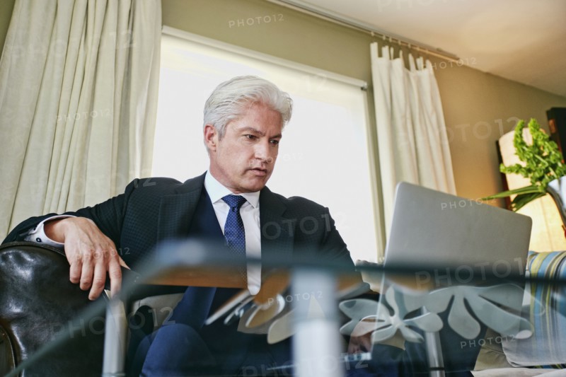Caucasian businessman working in living room