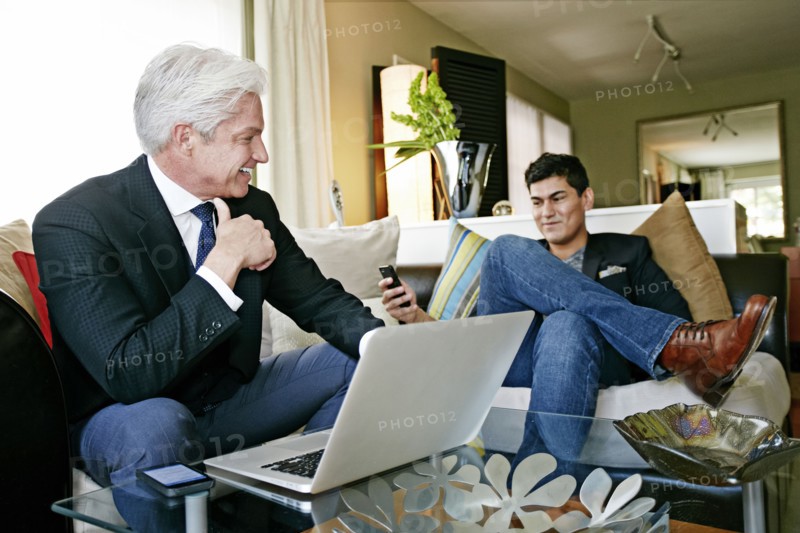 Businessmen talking in living room