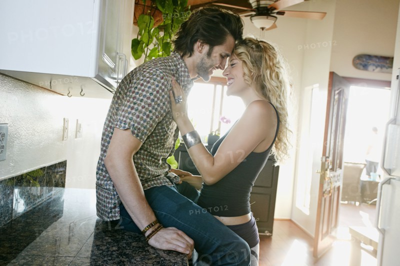 Couple hugging in kitchen