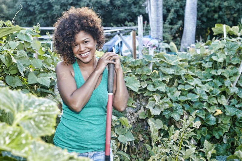 Mixed race woman working in garden