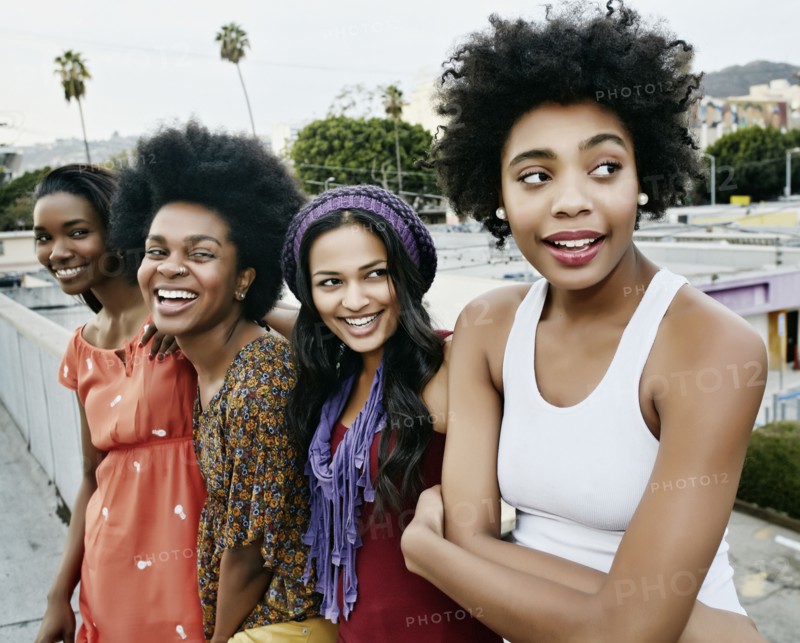 Women smiling on urban rooftop