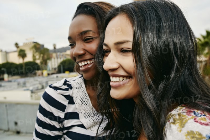Women smiling on urban rooftop