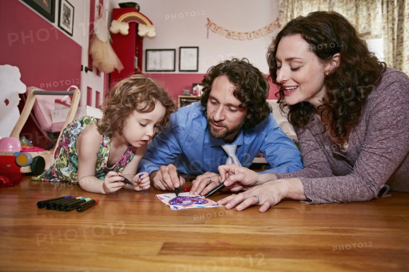 Caucasian family drawing in bedroom