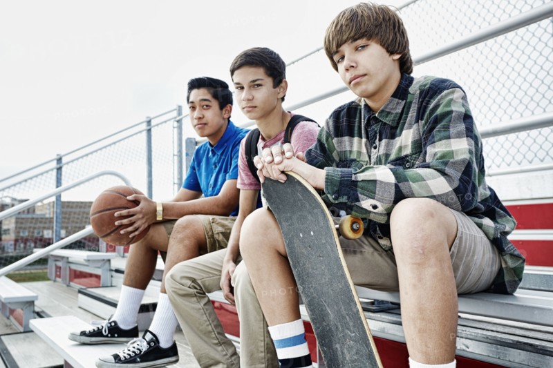 Teenage boys sitting on bleachers