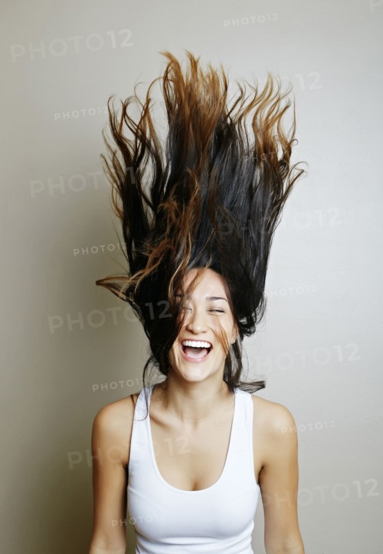 Mixed race woman tossing her hair