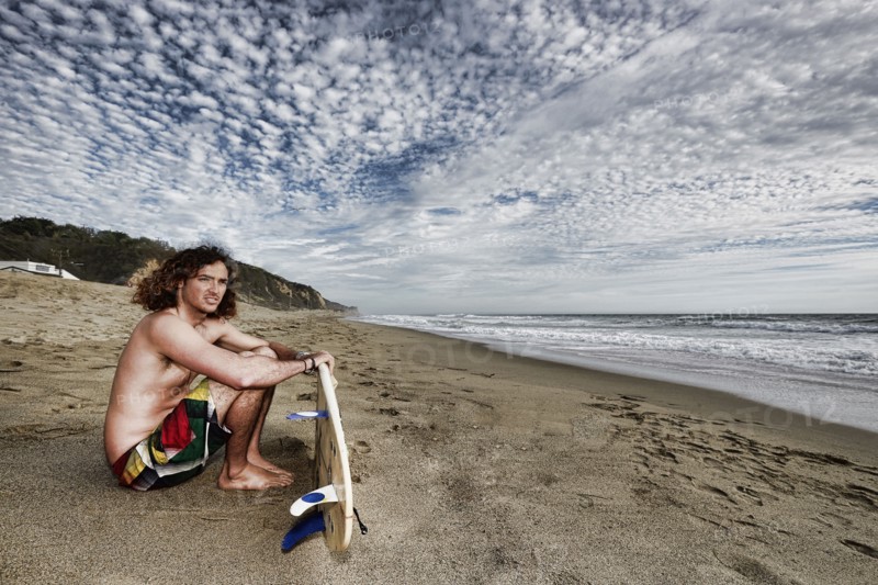 Caucasian man holding surfboard on beach