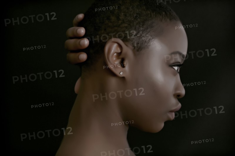 Black woman with hand behind head