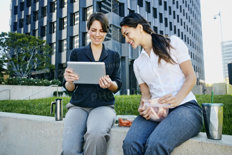 Businesswomen using tablet computer in city