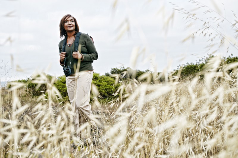 Black woman hiking on rural hillside