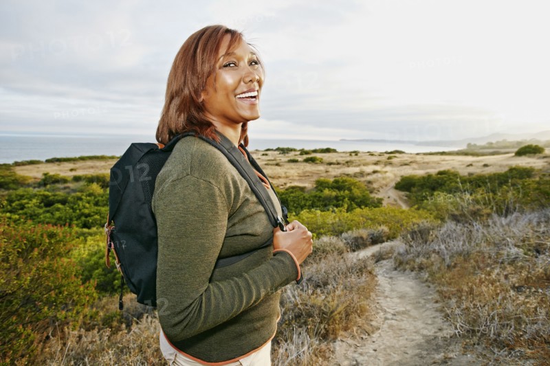 Black woman hiking on rural path
