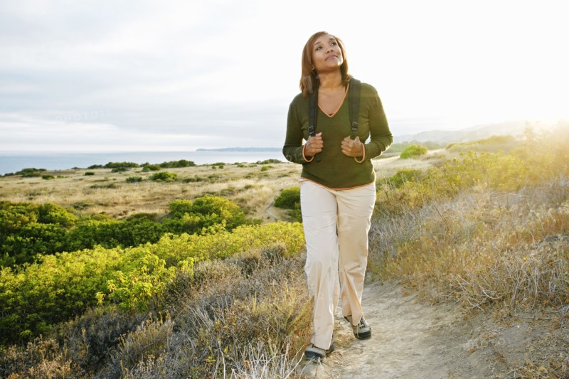 Black woman standing on rural hillside