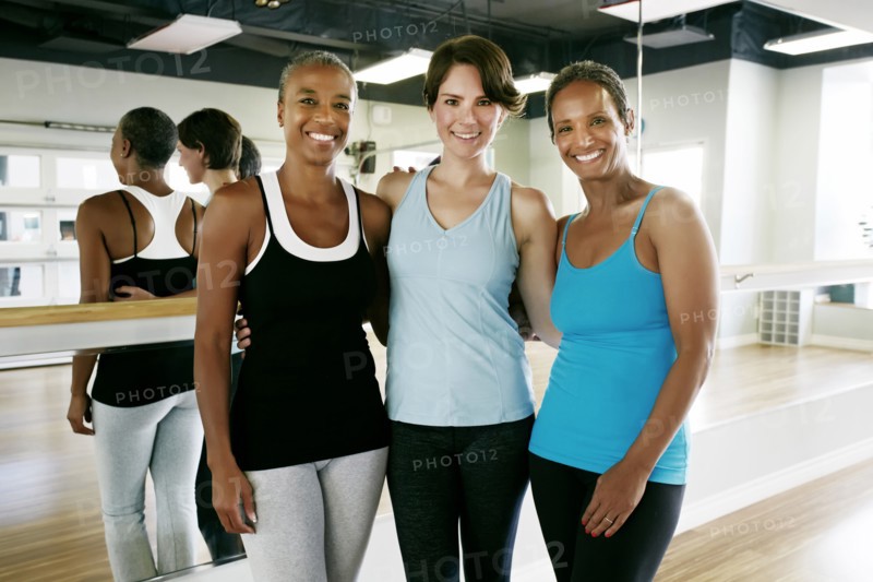 Women smiling together in yoga studio
