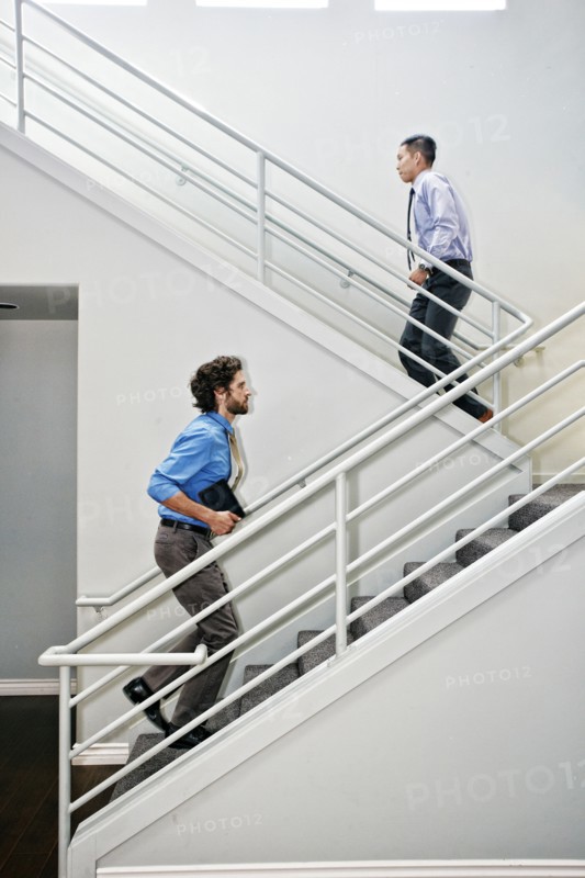 Businessmen climbing staircase