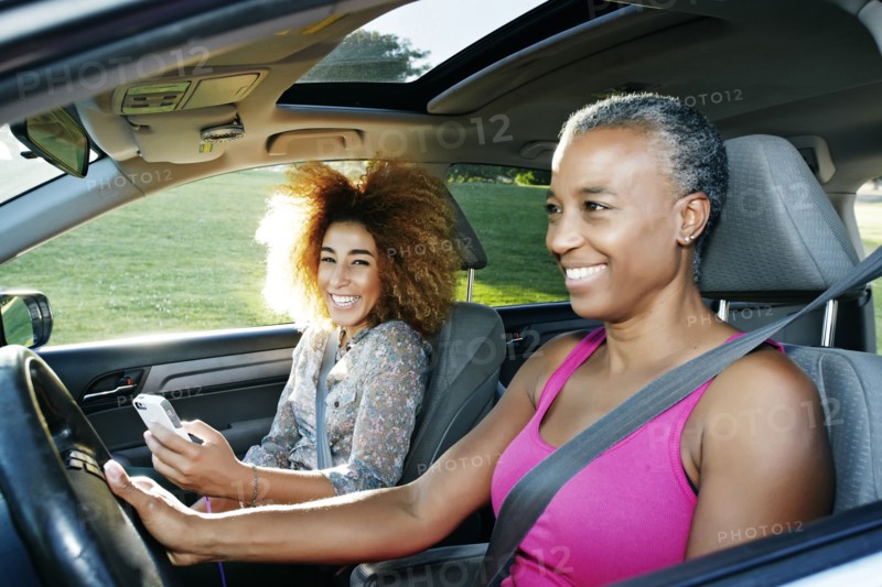 Mother and daughter driving car
