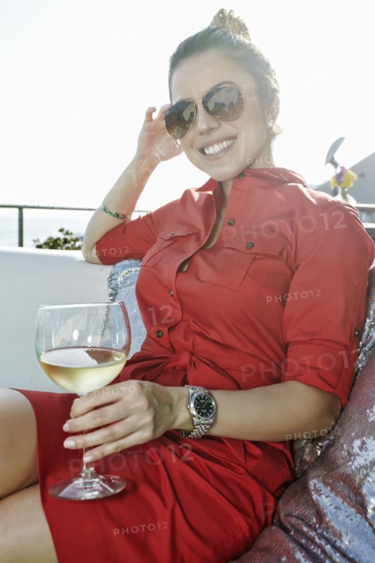 Mixed race woman drinking white wine