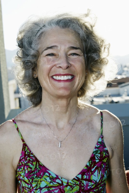 Caucasian woman smiling on urban rooftop
