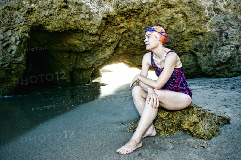 Older Caucasian woman wearing goggles and swimsuit on beach