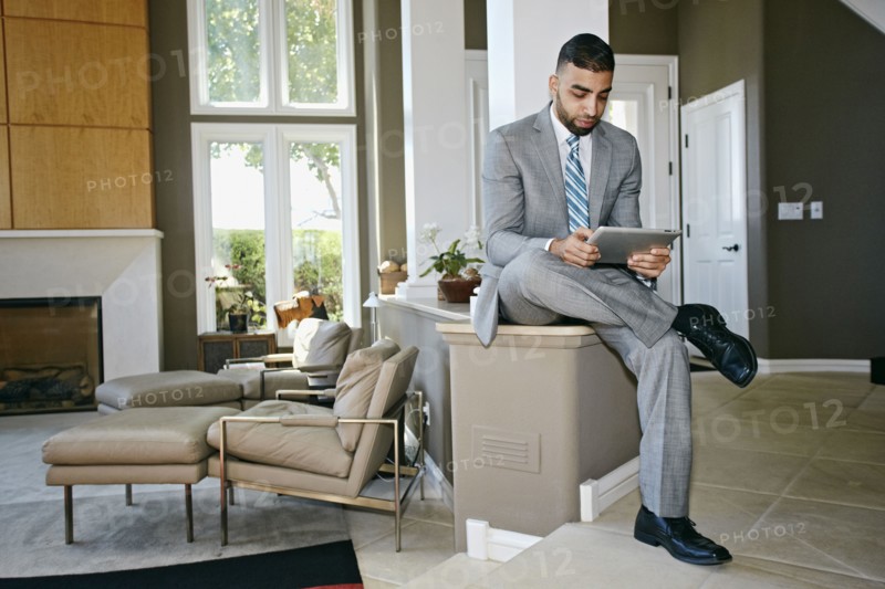 Middle Eastern businessman using digital tablet at home