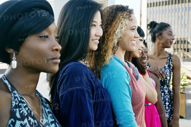 Women smiling on urban rooftop