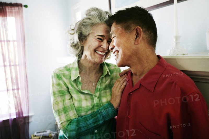 Smiling couple hugging in living room