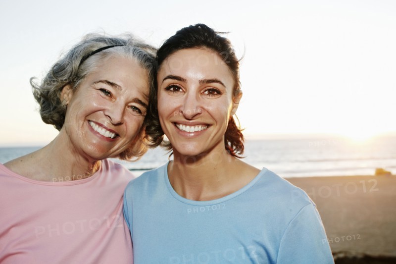 Caucasian mother and daughter hugging at beach