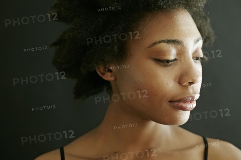 Close up of smiling black woman looking down