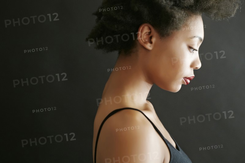 Close up profile of black woman looking down