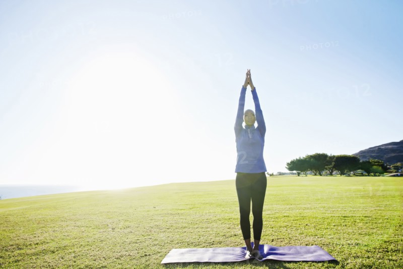 African American woman practicing yoga in park