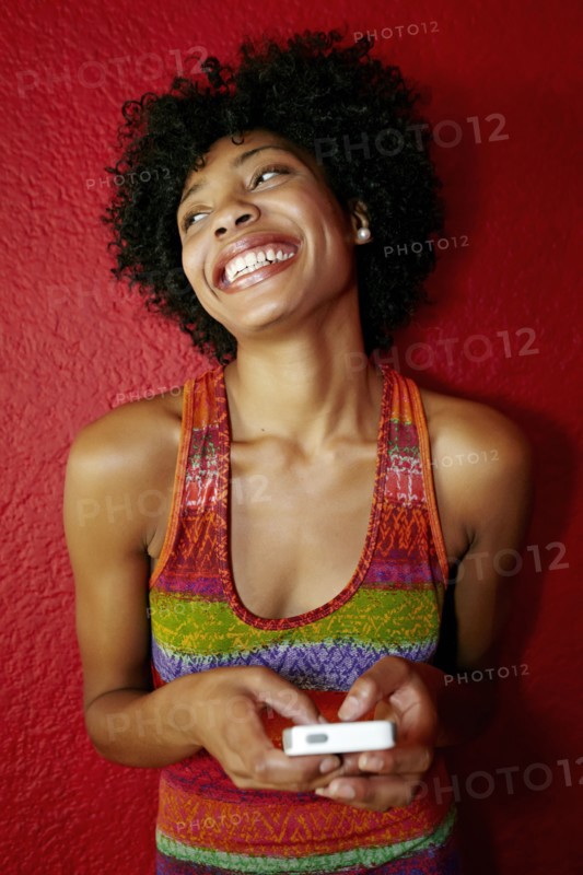 Smiling black woman using cell phone