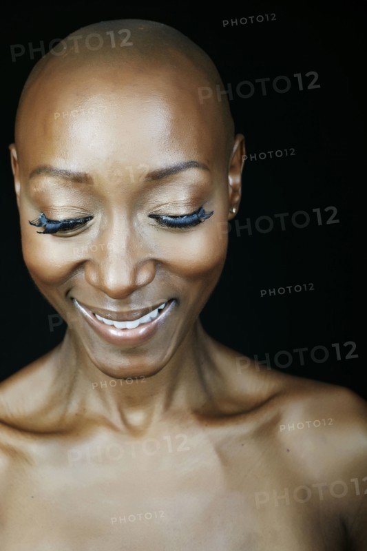 Close up of smiling face African American woman looking down