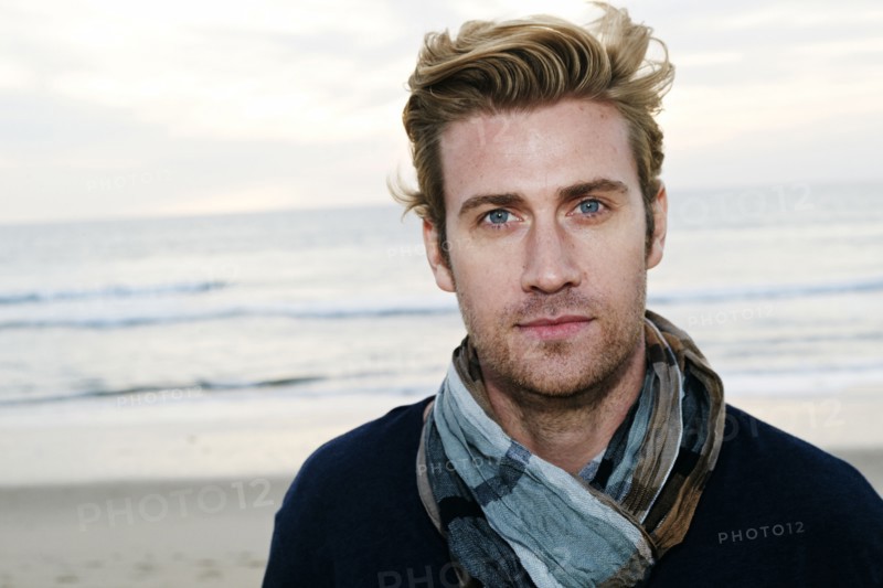 Caucasian man standing on beach