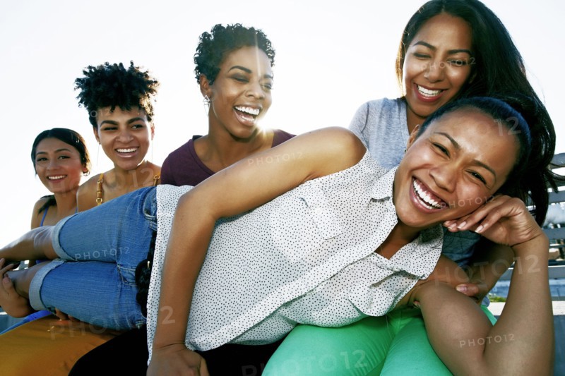 Women smiling on urban rooftop