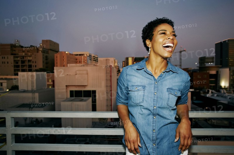 Woman laughing on urban rooftop