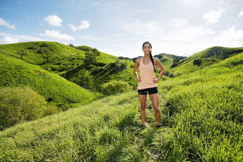 Mixed race athlete standing on rural hillside
