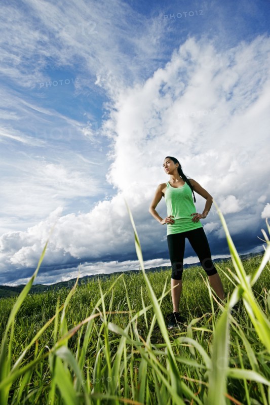Mixed race athlete standing in rural field