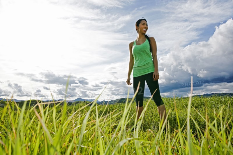 Mixed race athlete standing in rural field