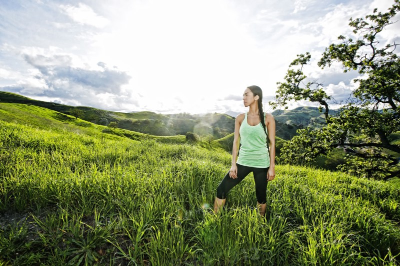 Mixed race athlete standing on rural hillside