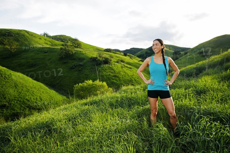 Mixed race athlete standing on rural hillside