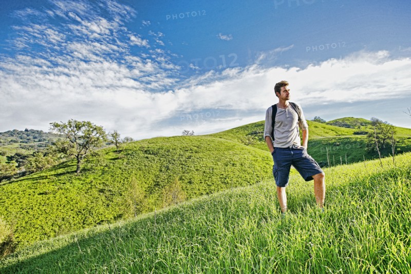 Caucasian man standing on rural hilltop