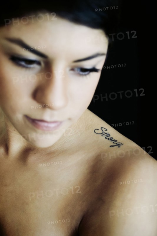 Hispanic woman with strong tattoo on shoulder