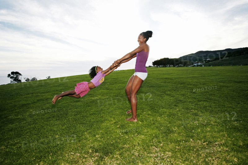 Mother and daughter playing in park