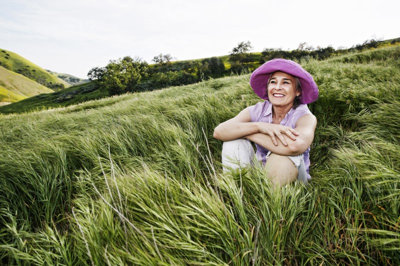 Caucasian woman sitting in tall grass