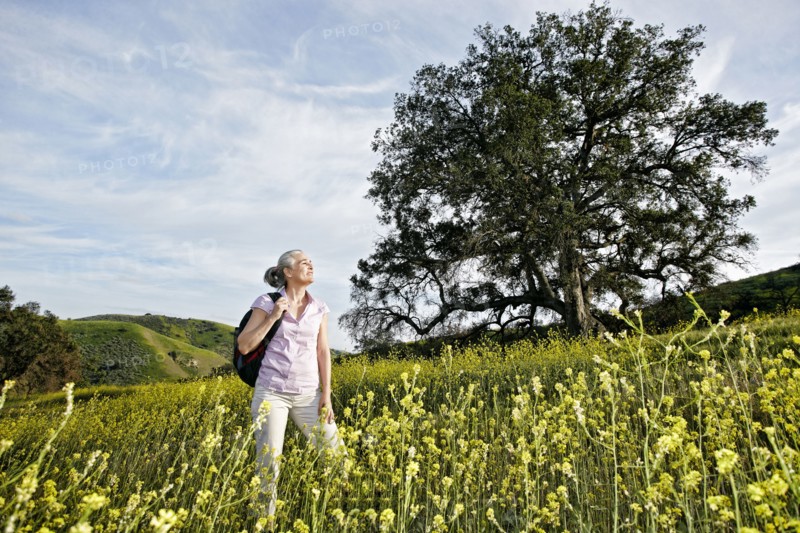Caucasian woman standing in tall grass