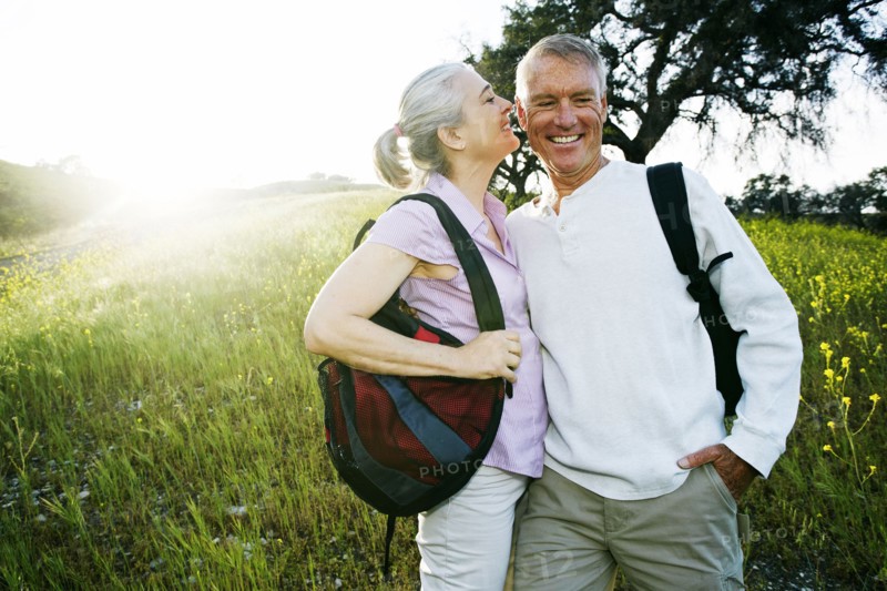 Caucasian couple kissing in tall grass
