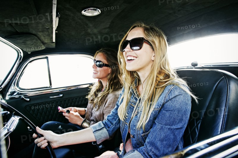 Women driving vintage car