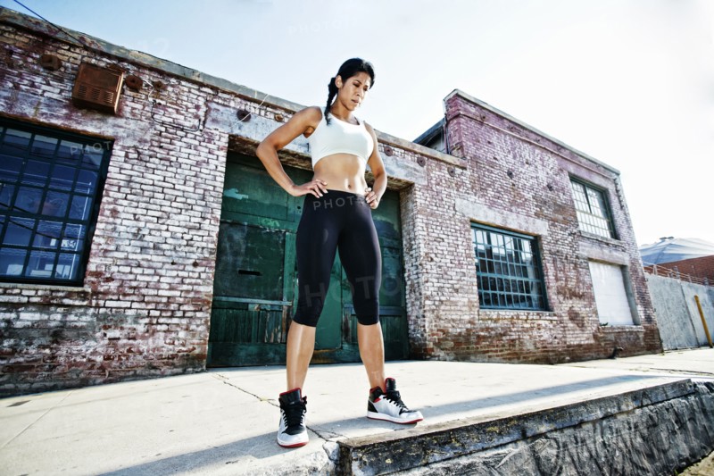 Mixed race woman standing on sidewalk