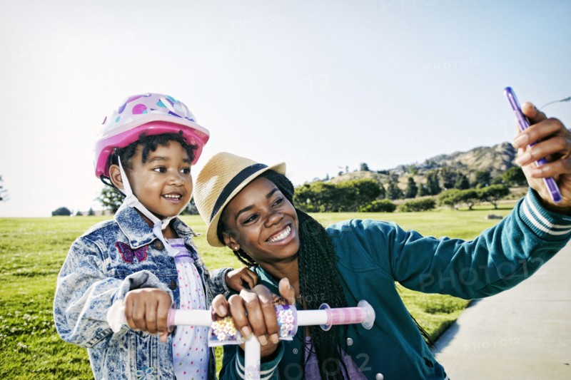 Black mother and daughter taking selfie