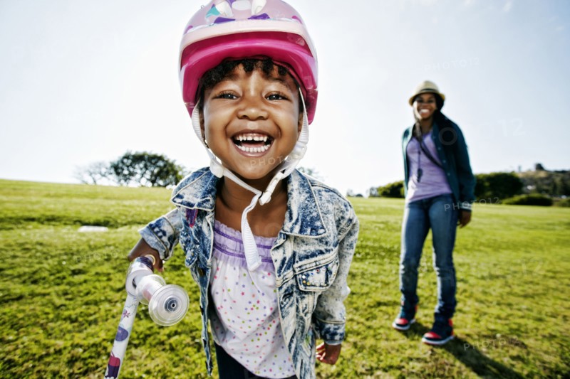Black mother and daughter playing in park