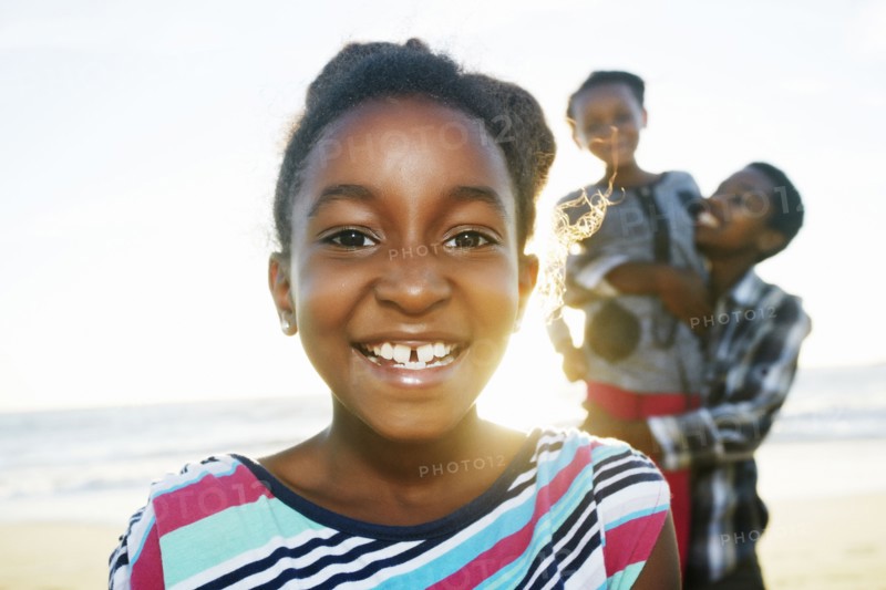 Black girl smiling on beach