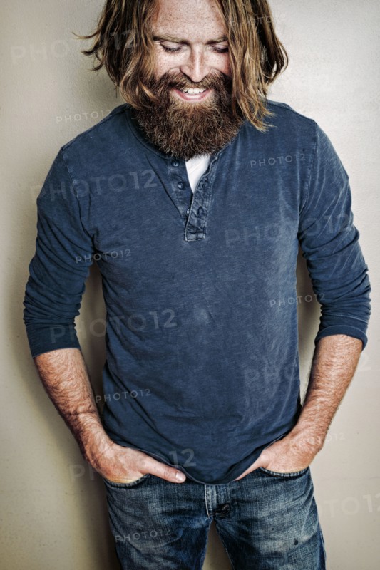 Caucasian man standing with hands in pockets